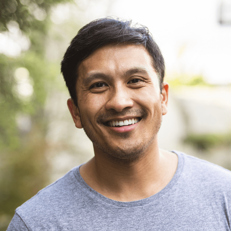 Adult man smiling outside